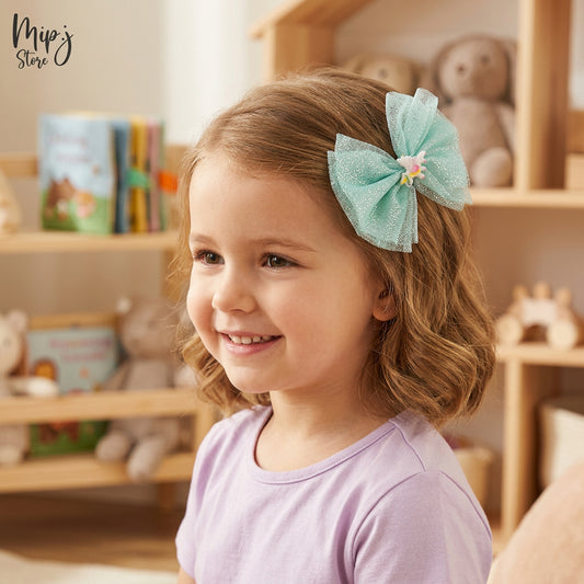 one pink glittery hairband and one eligator clip with unicorn designs placed on a cylindrical object

Details